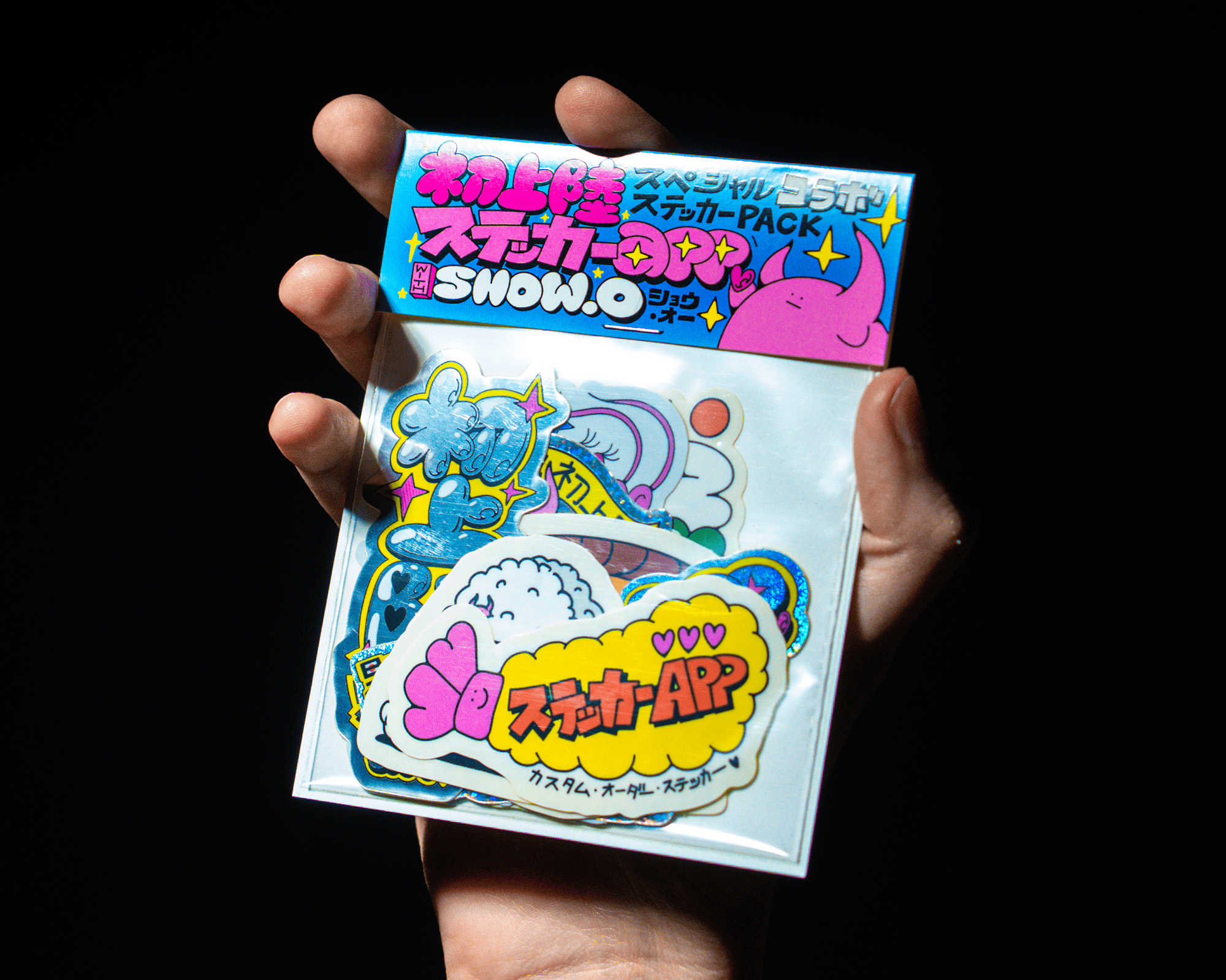 A hand holding a stickerpack